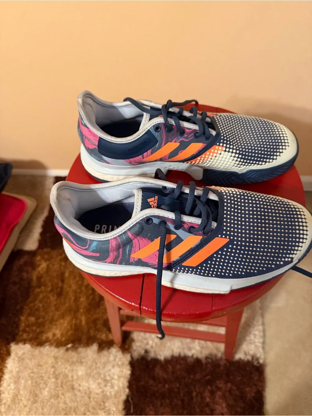 adidas navy athletic sneakers with orange stripes and pink accents
